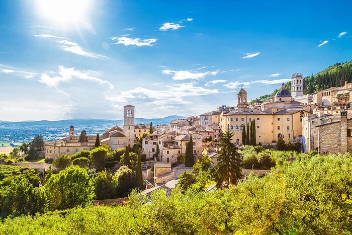 assisi italy view from the town with greenery high towers and buildings