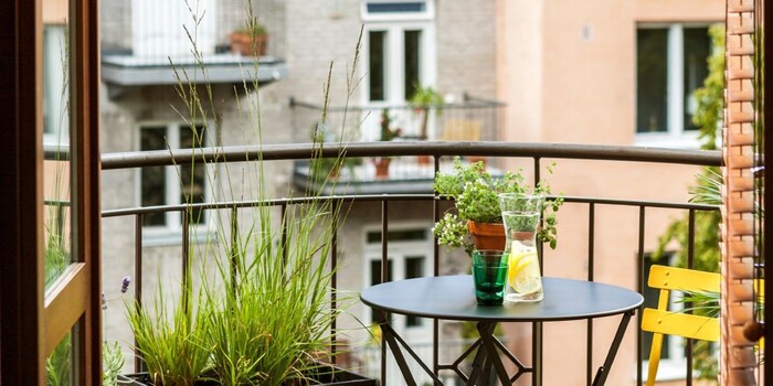 balcony garden small urban balcony with a view small table with a yellow chair and grass plants