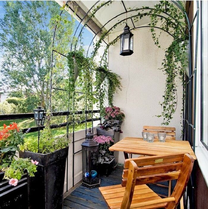 balcony privacy small balcony with a wooden table and chairs living plants a lantern and an arch