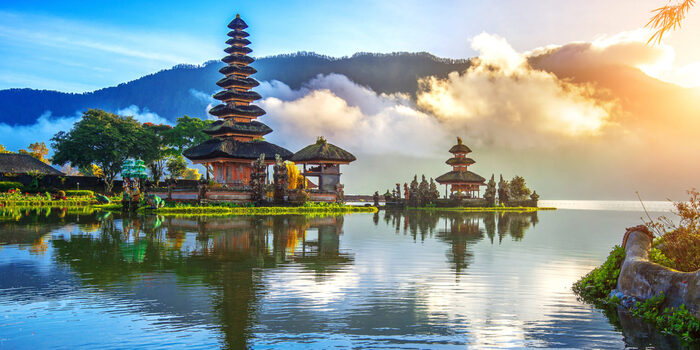 Bali landscape water with temples in the background with mountains and clouds