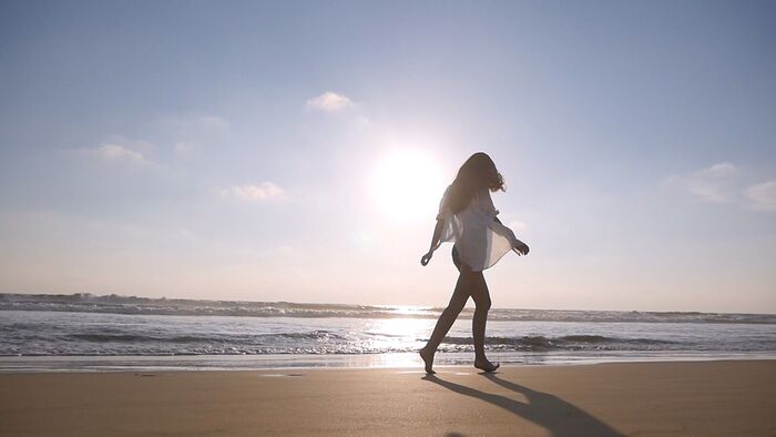 beach walk woman walking on a beach at sunrise