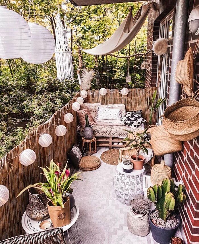 cute boho balcony with lanterns plants seating area and other accessories