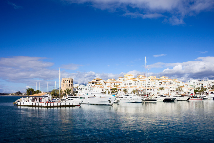 saling with a yacht white yachts on the background coastal town