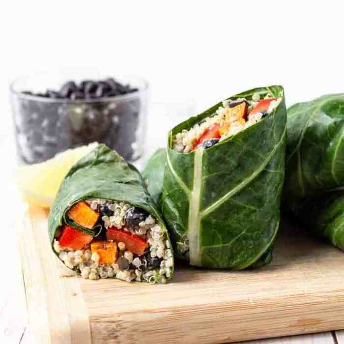 green wraps with a green leaf filled with veggies on a wooden board