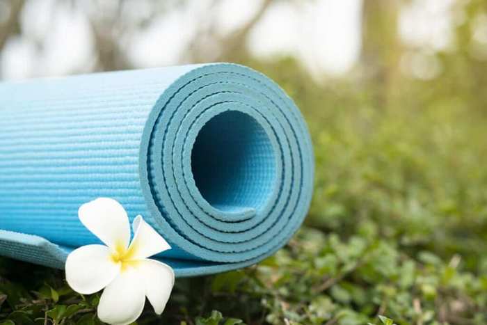 outdoor blue yoga mat with a white flower garden yoga spot