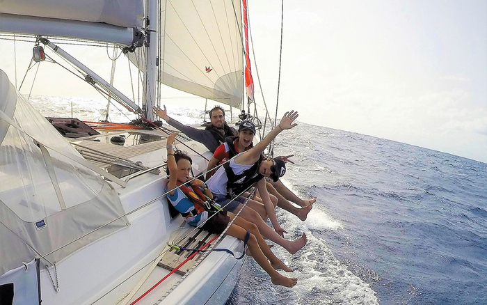 friends on a yacht enjoying the ride in the sea 