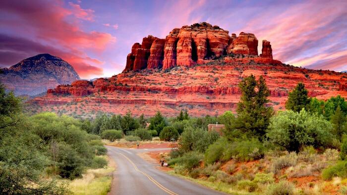 red mountains in sedona usa at sunset with low green trees around