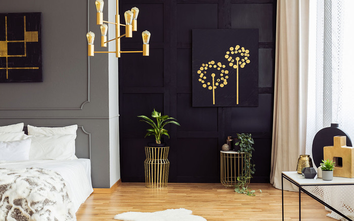 sleek dark bedroom interior with golden accents wall art and lighting fixtures