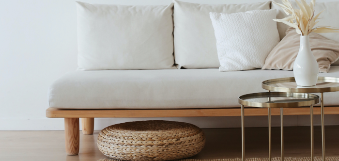 sleek living room with white couch and golden coffee table