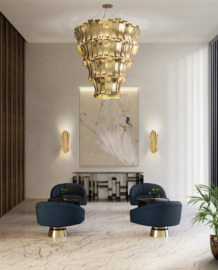 statement decor pieces large golden lighting fixture in a large living space with dark blue seating chairs 