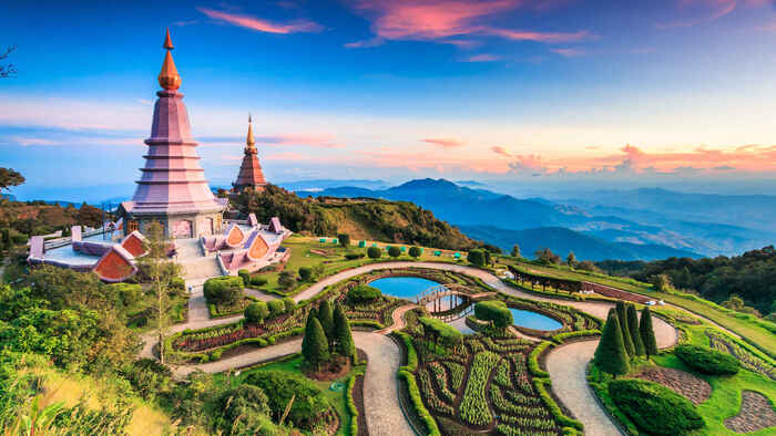 thailand landscape with temple towers overlooking a valley with beautiful gardens