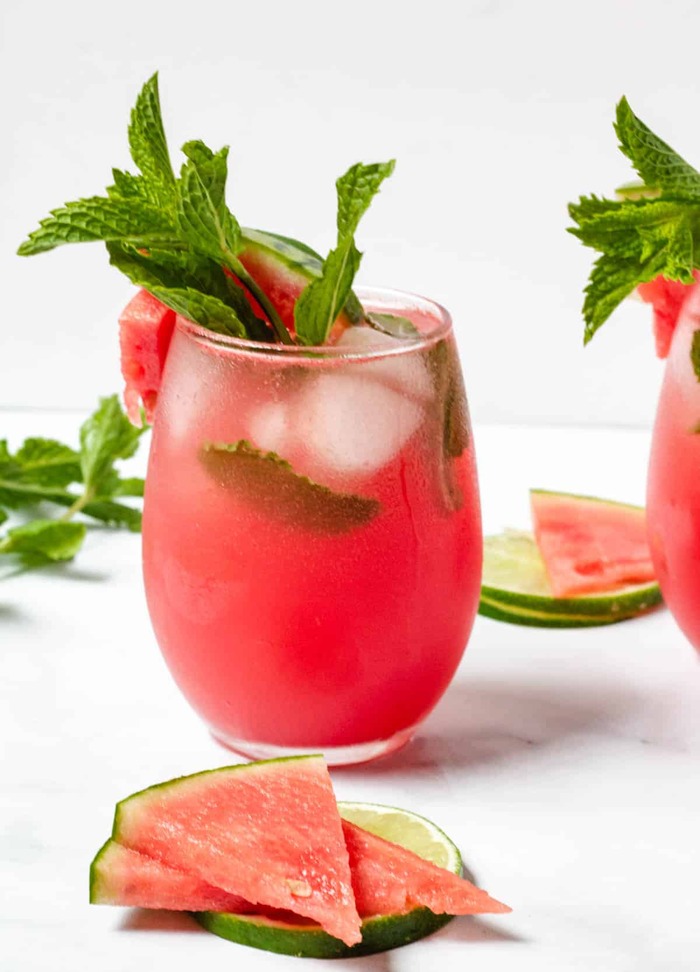 watermelon cocktail glass with slices of watermelon and peppermint leaves