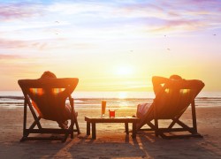 happy couple enjoy luxury sunset on the beach during summer vacations