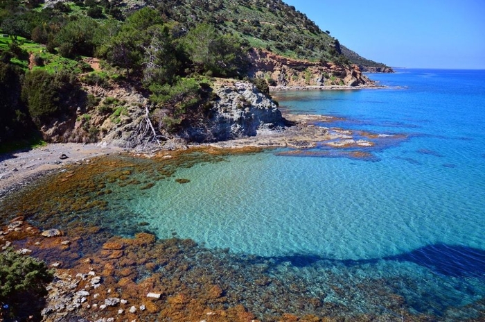 akmas national park virgin beach with clear water and rocks all around