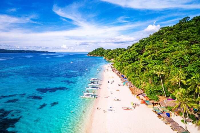 boracay island in the philippines clear water boats white sandy beach palm trees and exotic nature
