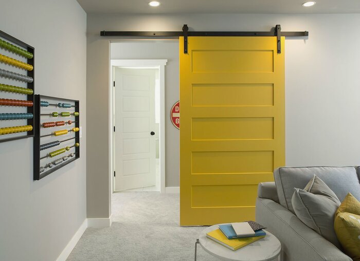 bright yellow accent sliding door in a modern living space with light furniture