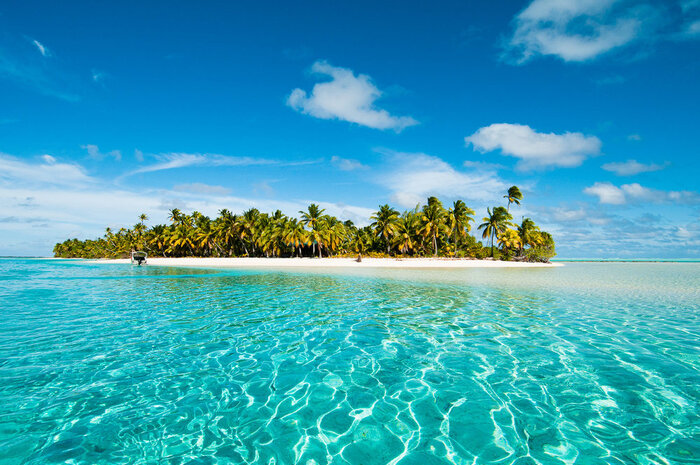 Tropical island with palm trees surrounded by blue water oasis tropical paradise