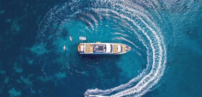 yachting summer a large yacht seen from above in a circle in the middle of the sea