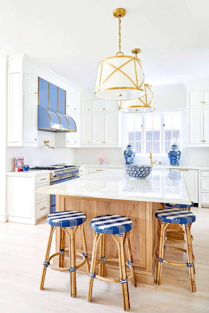 blue accents in the interior white and wood kitchen with bright blue accents and metal details