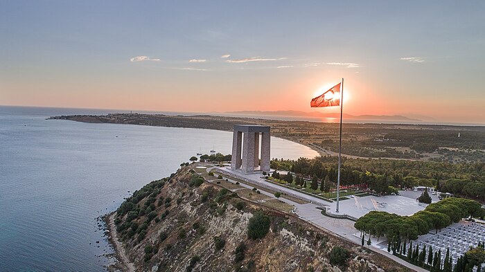 canakkale with the turkish flag and a large stone monument at cape above the sea