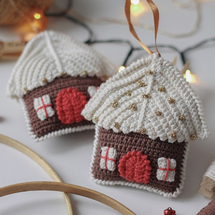 crochet christmas ornaments in the form of cute houses on a table