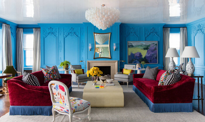 color trend bohemian blue living room with colorful furniture dark red sofas and artwork on the walls