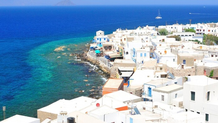 Dodecanese greek islands with white houses and beautiful blue sea around yachts in the sea