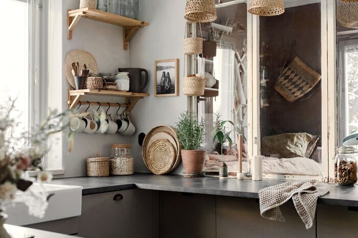 earthy tones and materials in a kitchen setting with large window and stone countertop