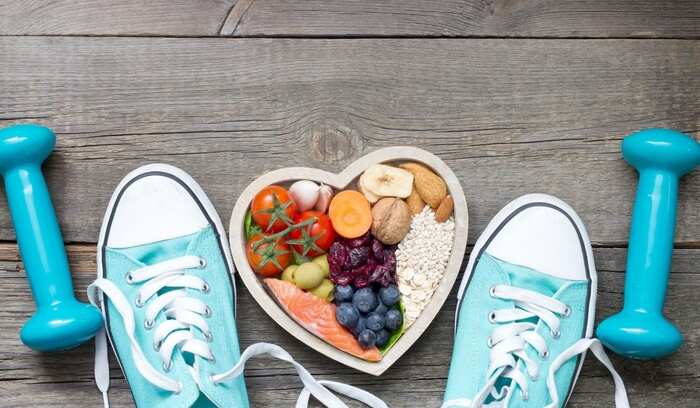 healthy life fitness and diet blue sports shoes heart shaped bowl with healthy foods