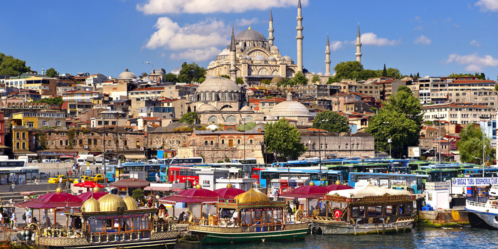 visiting Turkey a tourist picture from Istanbul with a large mosque in the background and boats in front