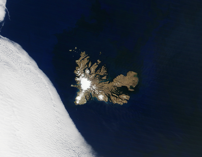 kerguelen island a spot in the large ocean with snowy tops close to a snow field remote islands