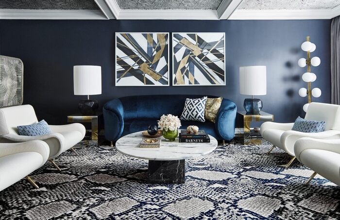 modern blue interior with snake print carpet and dark wall with art pieces and white furniture
