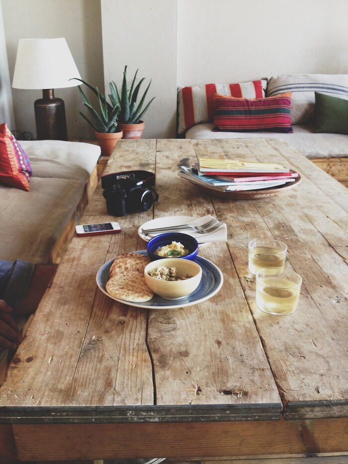 natural wood at home wooden table with food on it camera and living plants in the background