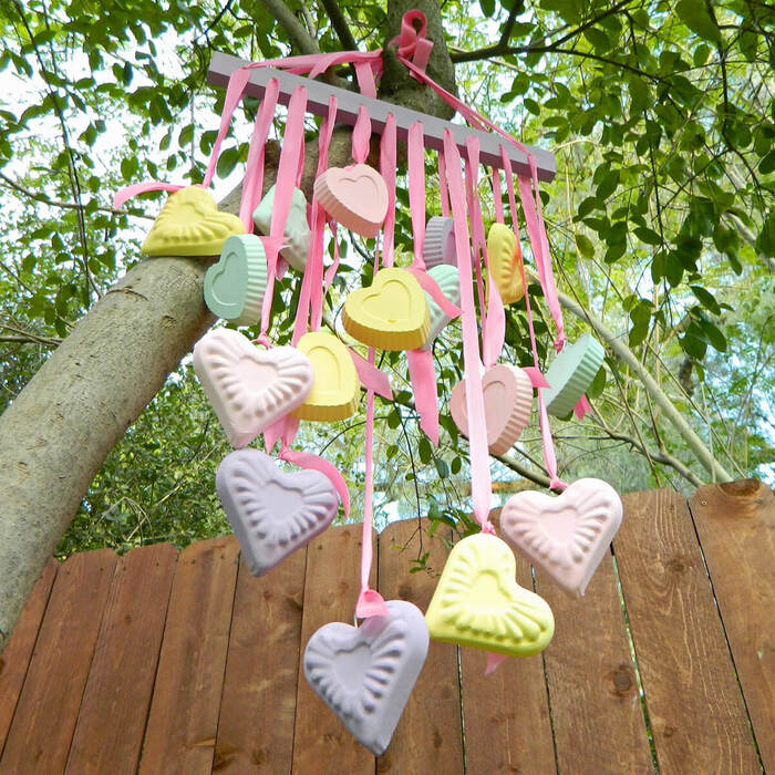 outdoor heart decor colorful bunch of hearts hanging from a tree outside