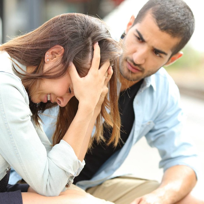 understanding narcissistic people couple fighting with a woman holding her head in her hands looking desperate