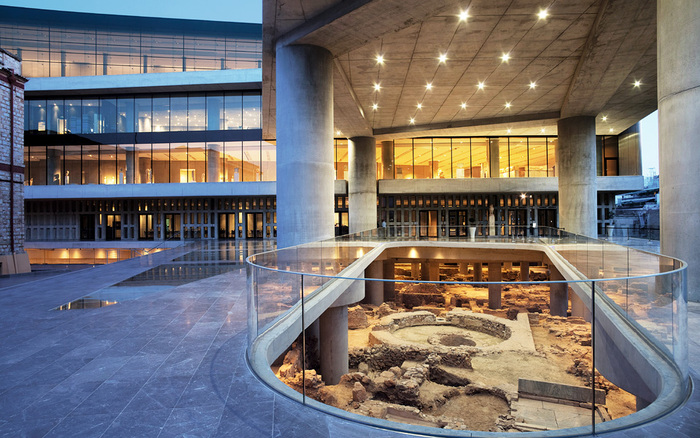 acropolis museum modern exterior with glass and concrete roof and columns ruins at the ground level