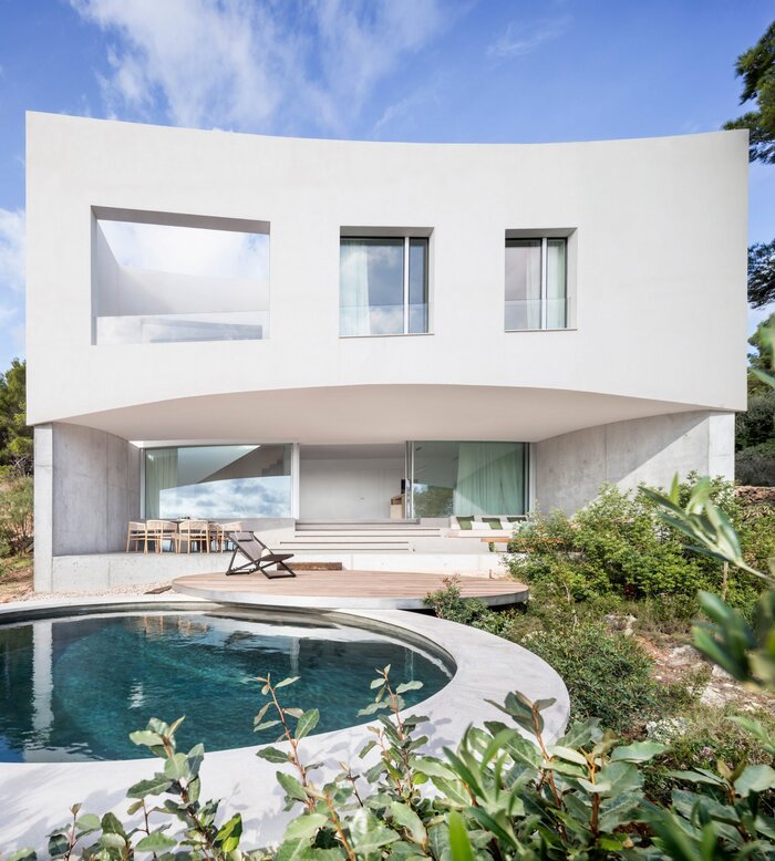 clean house exterior white house with a round pool and garden outside