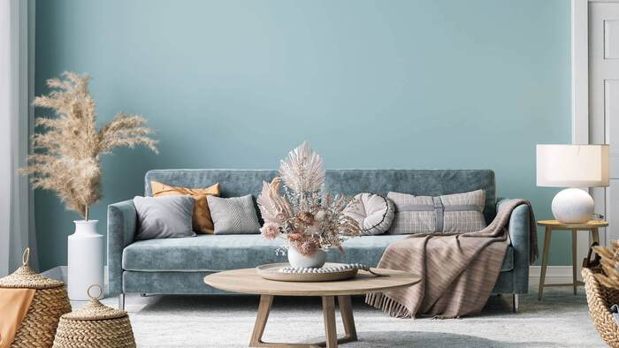 interior decor in a living room light blue sofa with natural decorations and a small wooden coffee table