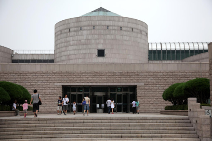 exterior of the national museum of korea people walking through the front door