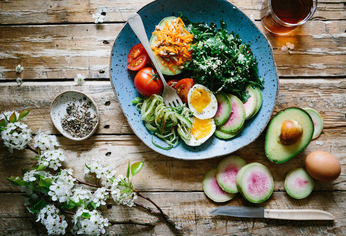 low blood pressure foods healthy meal arranged on a wooden table with a branch of blossoms on the side