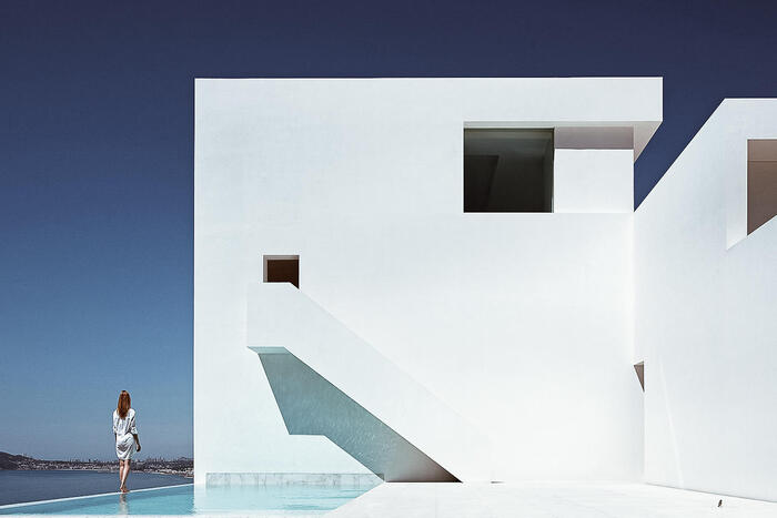modern home design sleek modern white building with a pool and woman standing on the outside