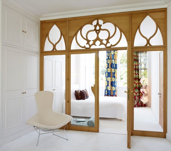 white space with a wooden and glass room divider to a bedroom