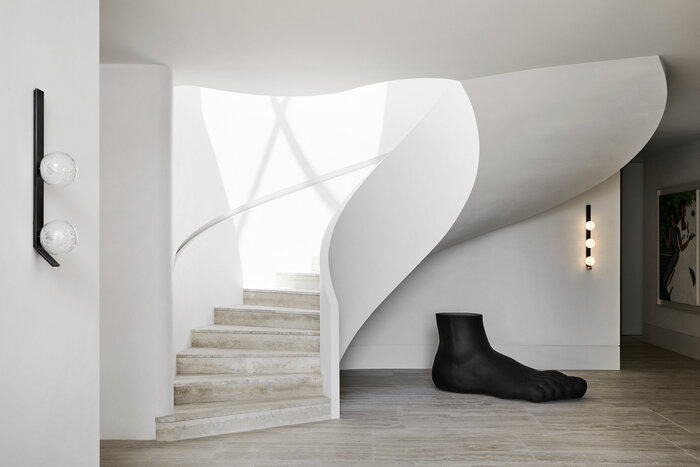 modern curves white staircase with a grey floor and a big black foot modern architectural design