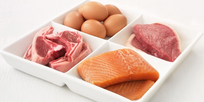 atkins diet in a white compartmented plate eggs two types of red meat and pieces of salmon