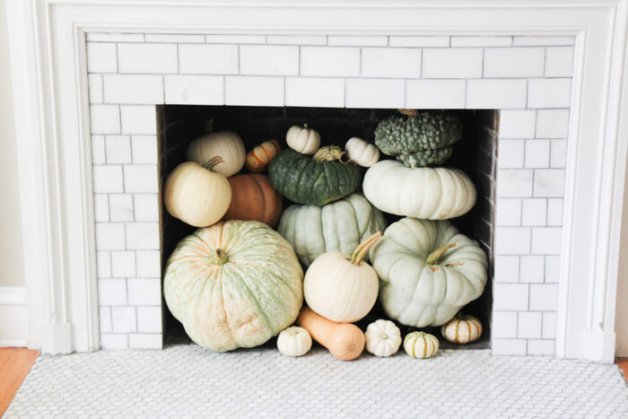 cute pumpkin fireplace white brick and tile fireplace filled with pumpkins of different colors and sizes