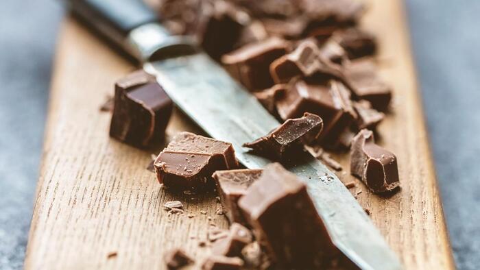 healthiest chocolate on a cutting board pieces of chocolate cut small