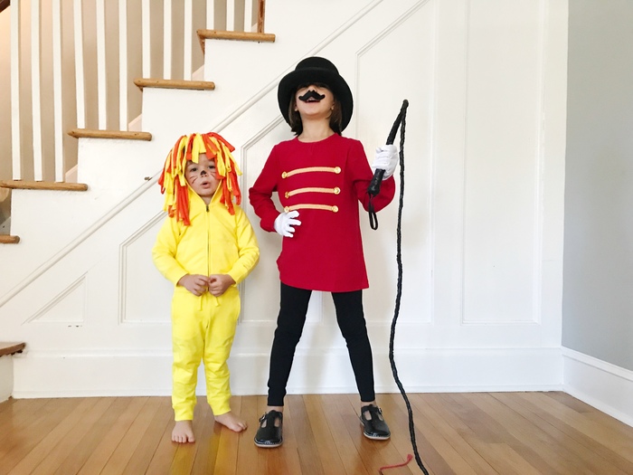 lion halloween two kids next to a staircase dressed as a lion and a circus tamer