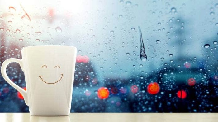 rainy day emotions white mug with a smiley face on a white window sill