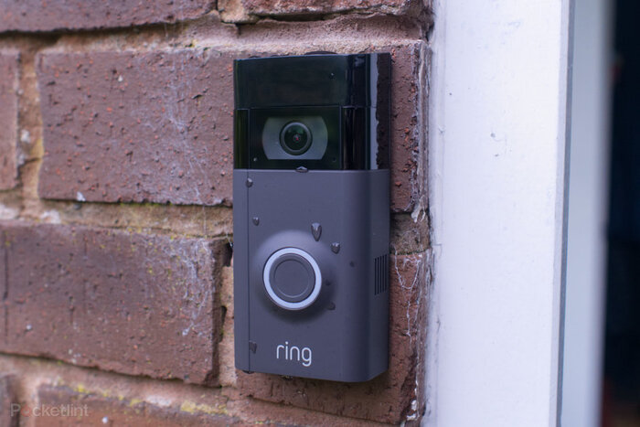 video ring doorbell in dark grey color on the wall next to the door