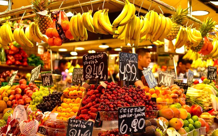 La Boquería market in Barcelona a food stand with many different fruits and their price tags